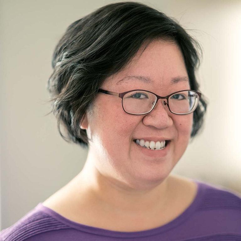 Lisa Kwong, seen wearing glasses, smiling.